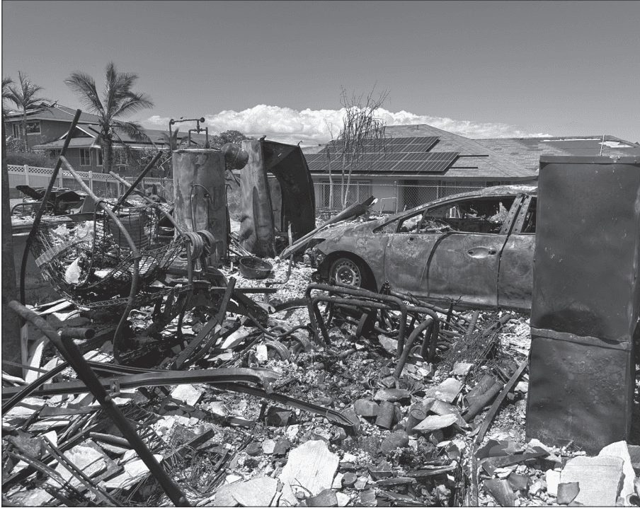 A burnt out car and home, the result of the deadliest U.S. wildfire in a century, the Lahaina Fire on the Hawaiian island of Maui, which killed 102 people, destroyed 2200 buildings and caused more than $5 billion in damages in August 2023. Headwaters Economics reports that more than 1,100 communities in 32 states face similar risks to Lahaina and Los Angeles and other places with recent urban fires. What may begin as a wildfire in woodlands or brush then spreads to buildings, which become the main source of fuel.